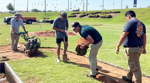 Michael McGregor learns the proper way to lay sod in his classes.